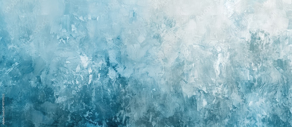 A painting of blue and white paint on a wall, showcasing a grunge texture with a light blue or cyan hue, resembling stucco or handmade winter Christmas paper.