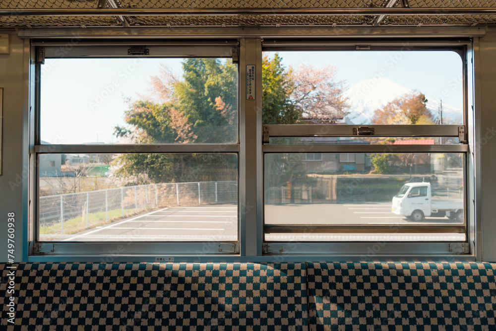 View of Fuji Mountain and country village from local train in Yamanashi, Japan