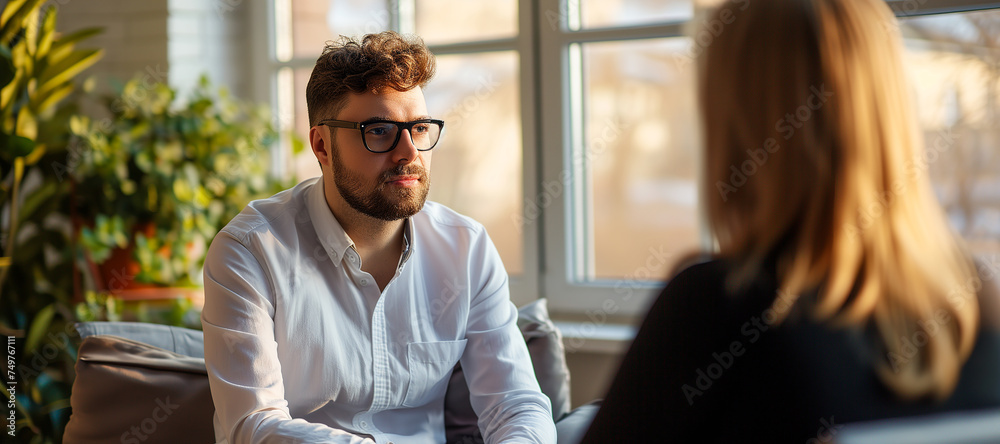 A female psychologist talks to a patient in her office. The concept of self-care, mental health. Doctor's appointment, close-up portrait, bokeh effect in the background. A female psychologist talks to a patient in her office. The concept of self-care, mental health. Doctor's appointment, close-up portrait, bokeh effect in the background.