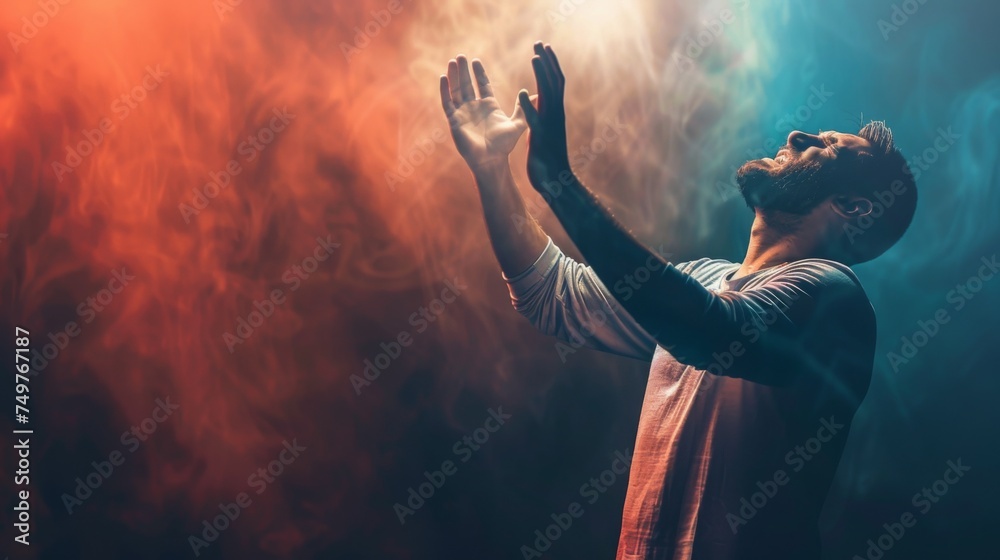 A Christian man praying to God crying and emotional with his arms raised