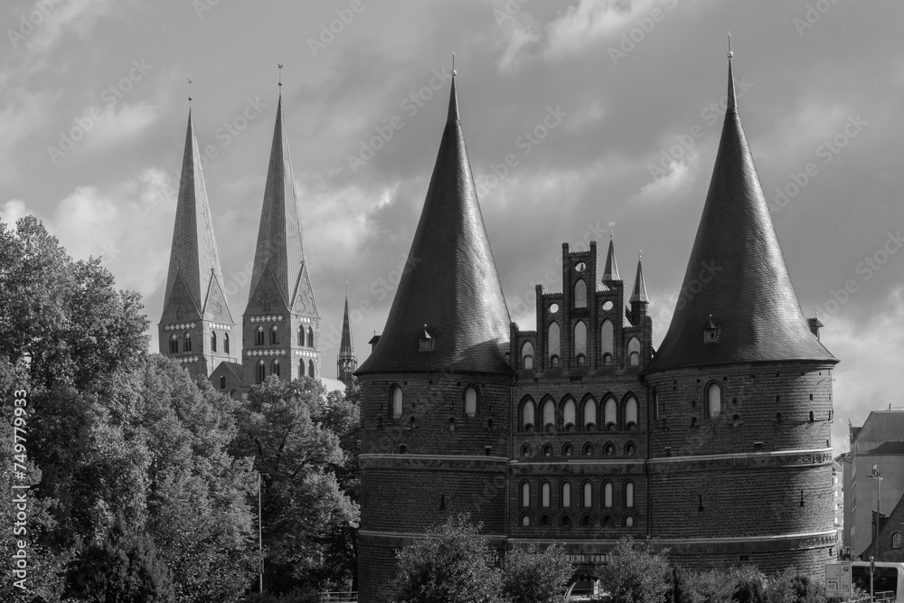 View to the Holsten Gate and the St. Marys Church in Lübeck,  black and white.
