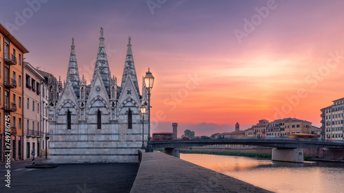 Arno river embankment with ancient Chiesa di Santa Maria della Spina church at sunset, Pisa, Italy photo