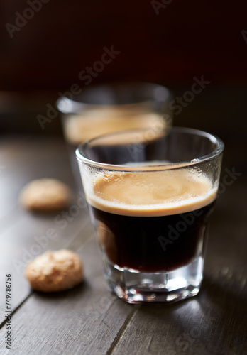Two Glasses Of Coffee on dark wooden background. Close up.