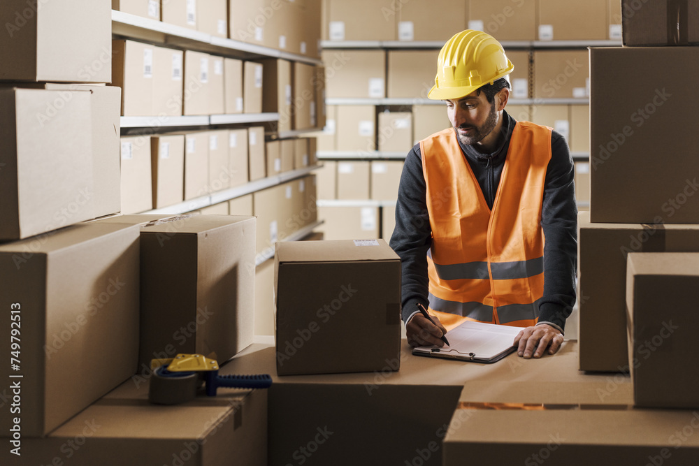 Warehouse worker checking orders and packages Warehouse worker checking orders and packages