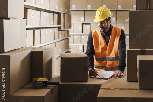 Warehouse worker checking orders and packages