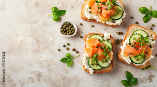 Open faced smoked salmon sandwiches with fresh herbs and cream cheese on rustic background photo