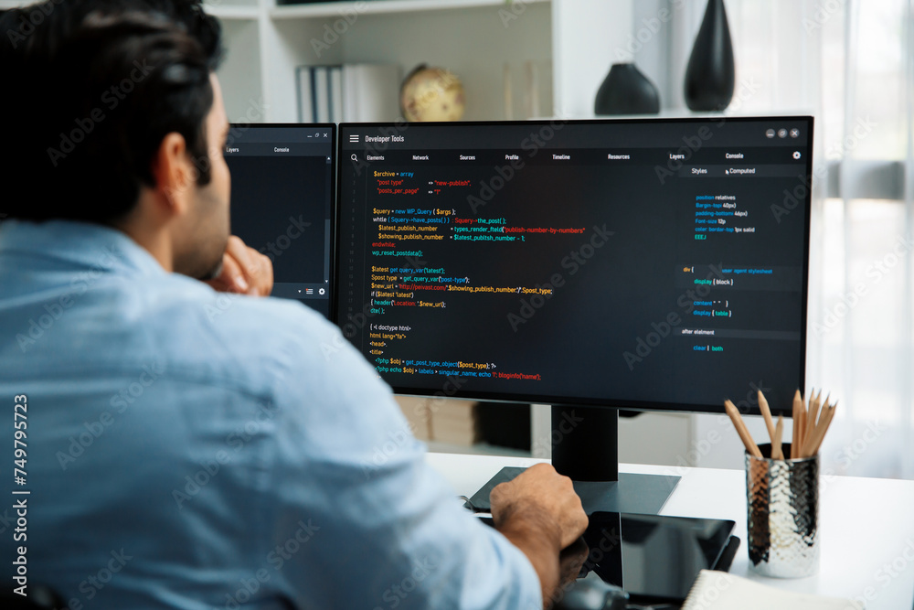 Concentrating in smart IT developer working software development coding on two pc screen, creating virus firmware application program for latest update version on website at modern office. Surmise.