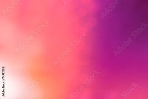 Soft and glowing orange, purple and pink color gradient background with bokeh effect. Abstract bright, vibrant, blurred and multi-colored background. Copy space.