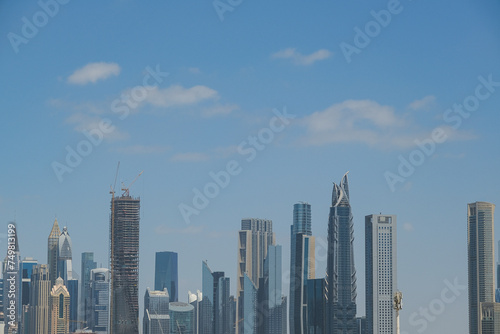 Futuristic and modern commercial and residential highrise tower skyscraper architecture with glass facades and clean lines in downtown Dubai  United Arab Emirates for millionaires and high society