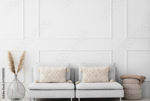 View of modern scandinavian style interior with sofa and trendy vase, Home staging and minimalism concept.