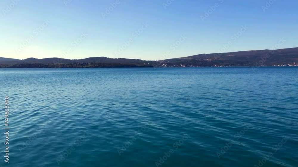 Calm sea with beautiful ocean and mountain views. Bay of Kotor. Adriatic Sea. Tivat, Montenegro. Europe. Calm sea with beautiful ocean and mountain views. Bay of Kotor. Adriatic Sea. Tivat, Montenegro. Europe.