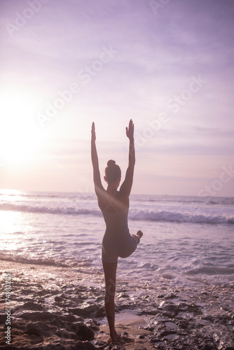 Woman Doing Yoga On The Beach