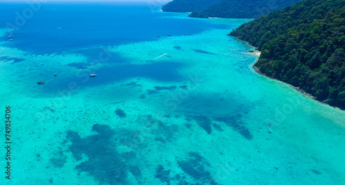The aerial view with tropical seashore island in turquoise sea Amazing nature landscape © SASITHORN