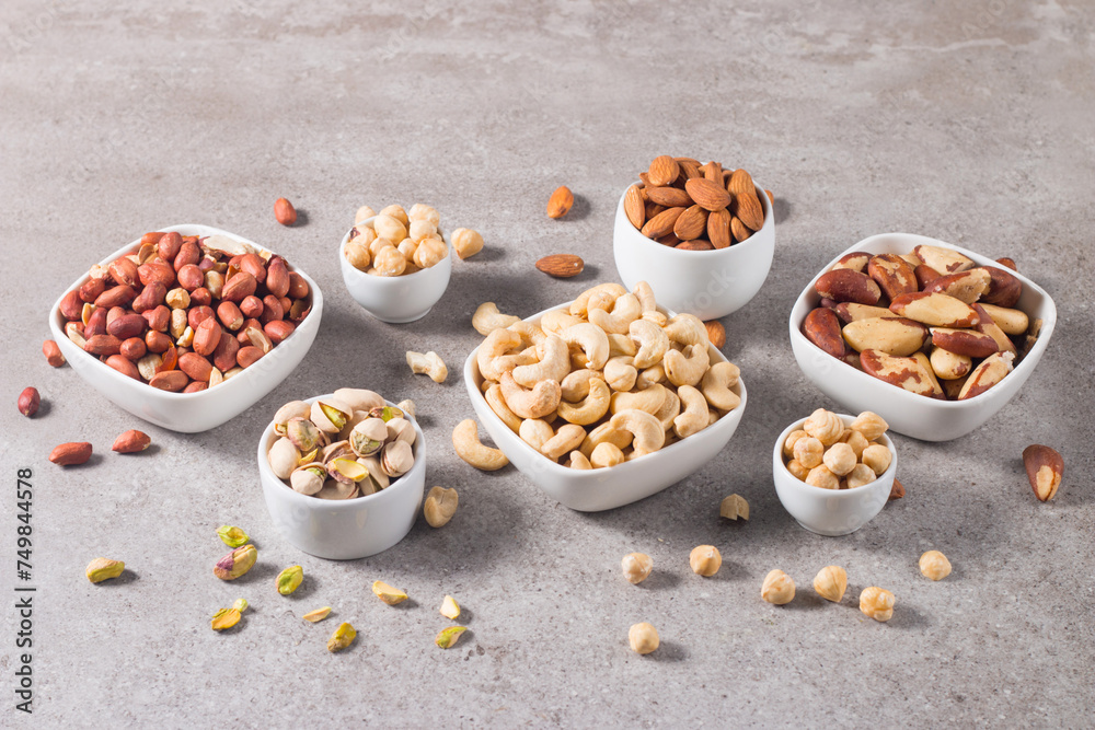 Healthy mix nuts and dried fruits on wooden background. Almonds, hazelnuts, cashews, peanuts, pistachios, Brazilian nuts Healthy mix nuts and dried fruits on wooden background. Almonds, hazelnuts, cashews, peanuts, pistachios, Brazilian nuts