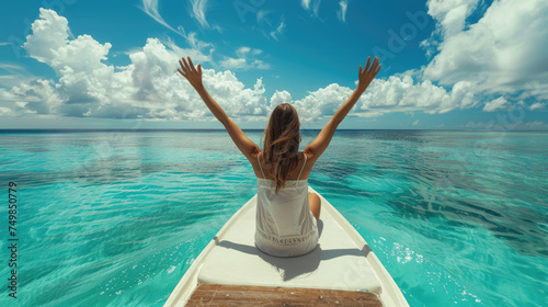 A happy woman is waving hand, relaxing on boat at clear blue sea beach on her summer holiday.