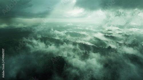 Aerial view of a mystical forest shrouded in mist and clouds, with a dramatic atmosphere and ethereal beauty.