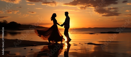 Silhouette of a couple dancing on the beach at sunset