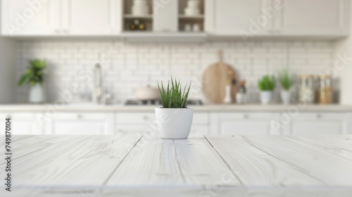 A small green succulent plant in a white pot on a wooden kitchen table against a blurred background.