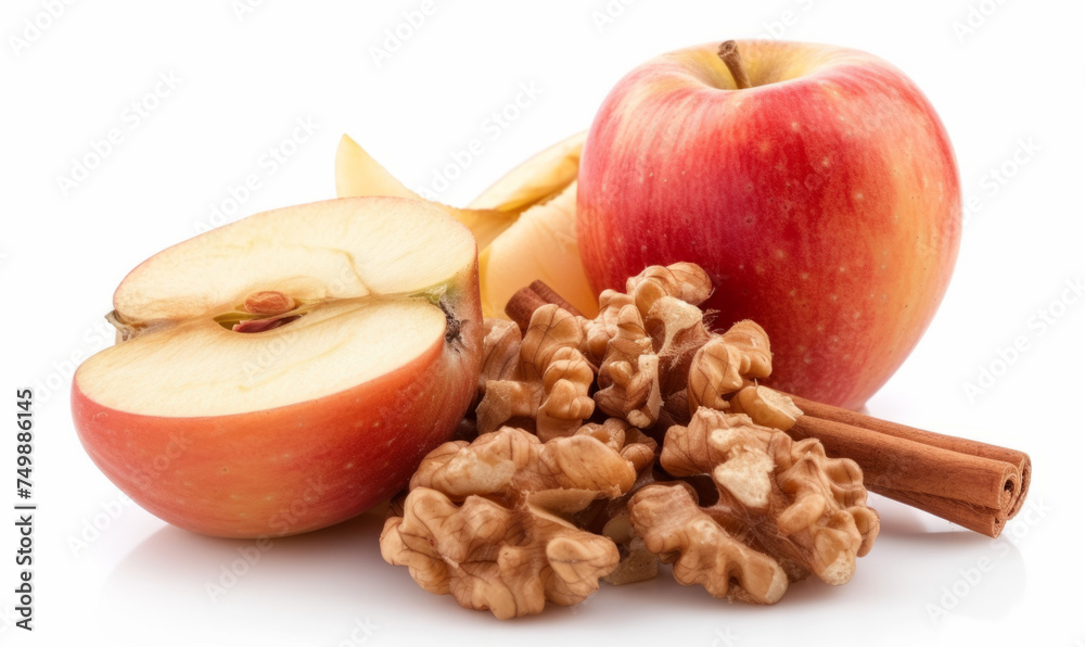 Whole and sliced apples with walnuts and cinnamon stick isolated on white background. Studio food photography for design and print