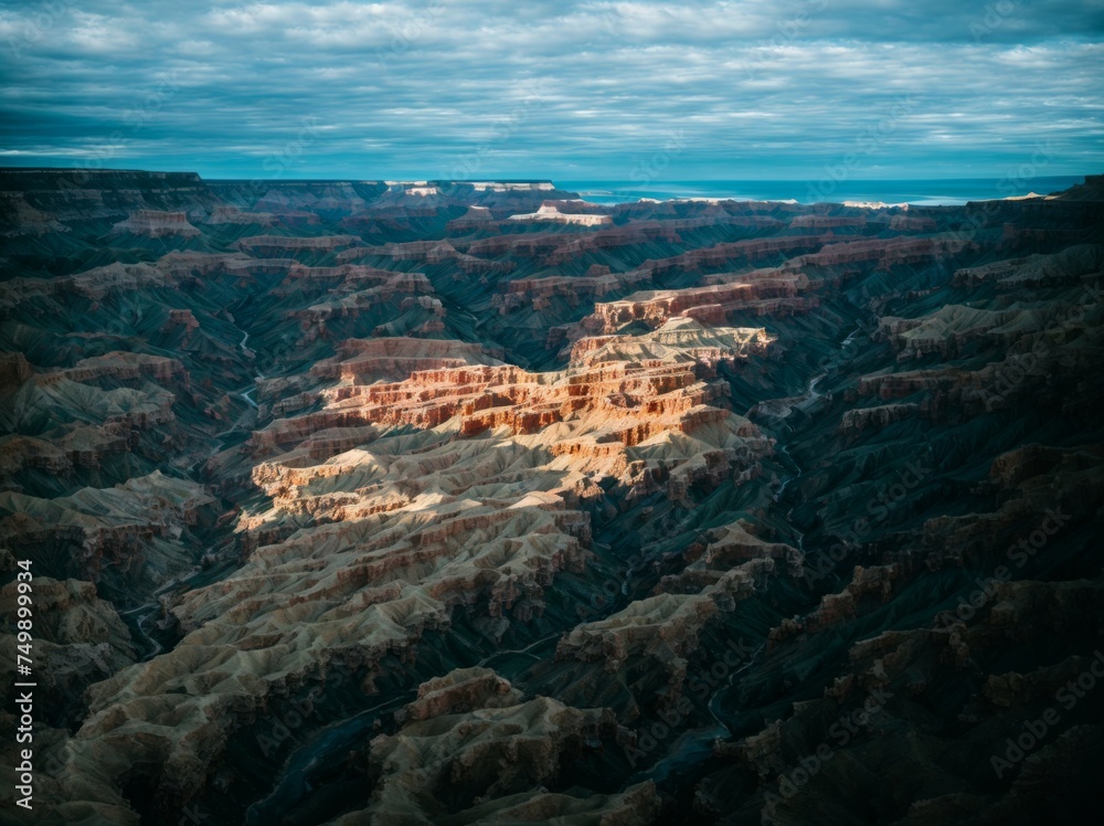 An all-encompassing aerial image captures a rugged canyon with coastal views 