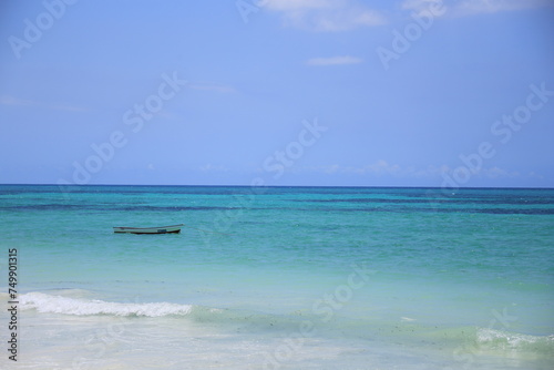 a rowing boat at the sand beach of Zanzibar