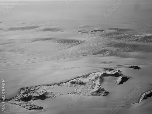 aerial black and white picture of greenland landscape with ice and glaciers photo