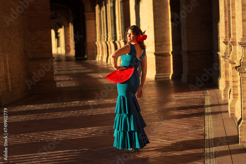 the girl with the flamenco dress and the fan ready to party