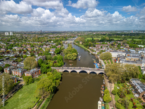 The drone aerial view of Thames River runs through Richmond town centre on the east bank with its neighbouring district of East Twickenham to the west, London, UK.