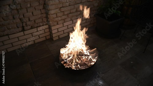 Intense Flames Rising from a Fire Pit in a Cozy Outdoor Patio Setting