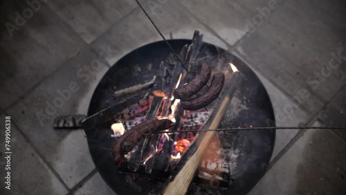 Open Fire Grilling of Sausages Over a Charcoal Fire Pit