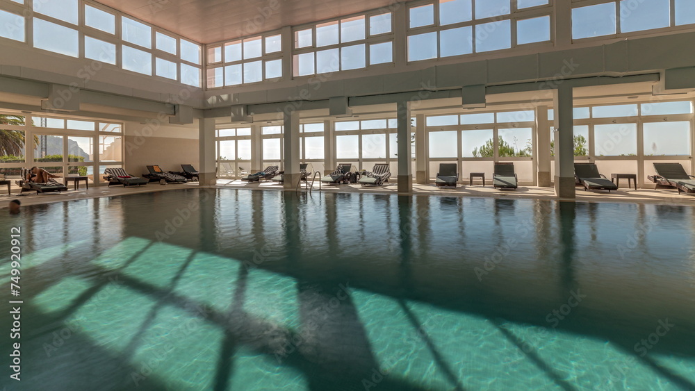 Panorama showing luxury indoor swimming pool, part of hotel timelapse