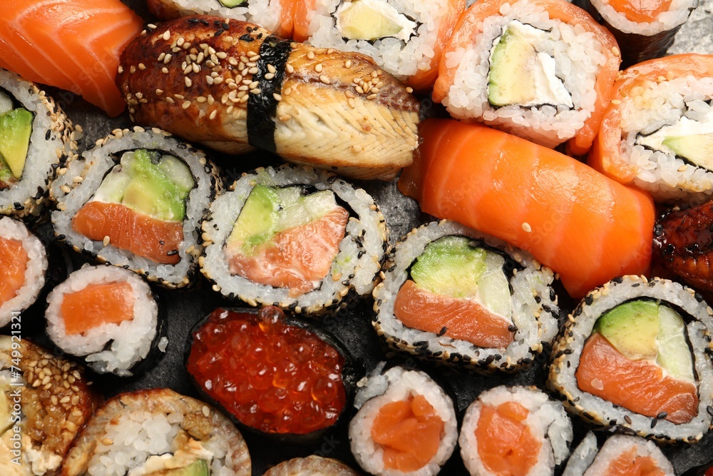 Different tasty sushi rolls as background, top view Different tasty sushi rolls as background, top view