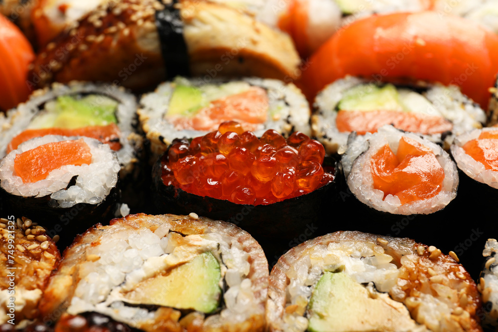 Different tasty sushi rolls as background, closeup Different tasty sushi rolls as background, closeup