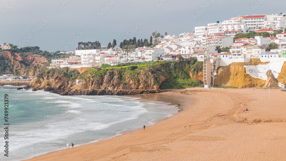 Wide sandy beach and Atlantic ocean in city of Albufeira timelapse. Algarve, Portugal