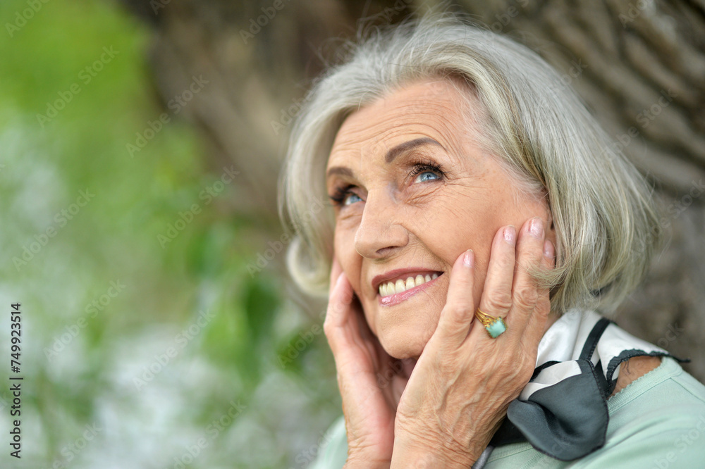 Portrait of happy senior woman posing at forest Portrait of happy senior woman posing at forest