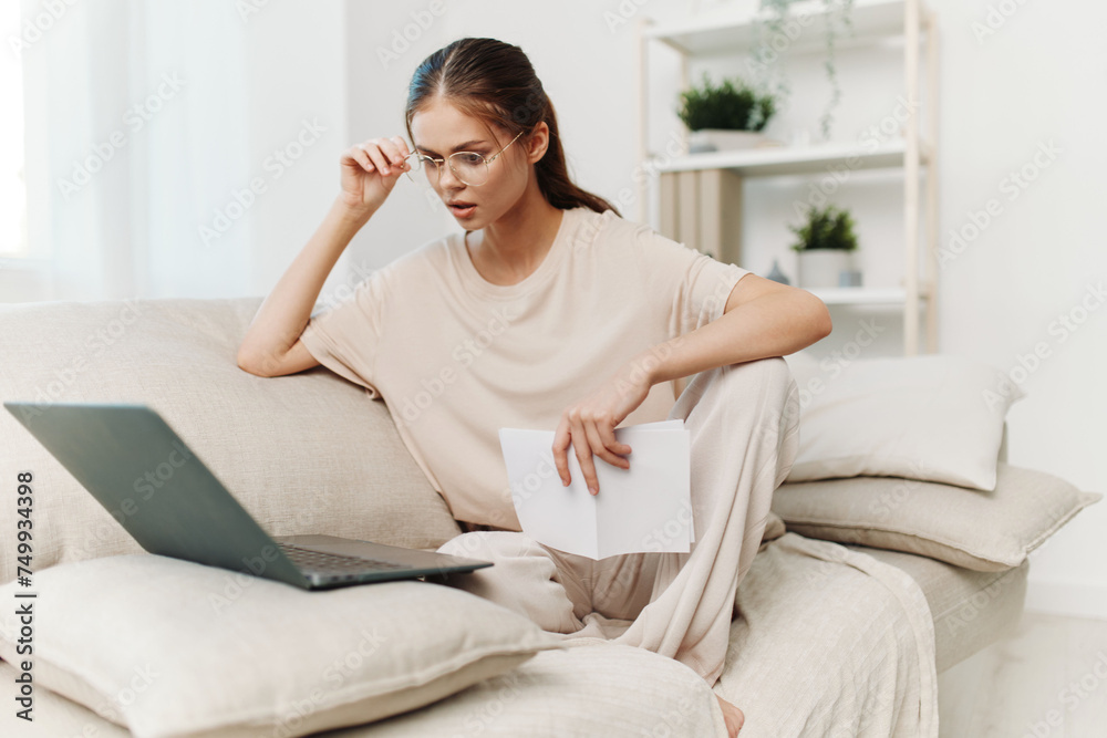 Smiling Woman Typing on Laptop in Cozy Living Room, Embracing the Modern Lifestyle Smiling Woman Typing on Laptop in Cozy Living Room, Embracing the Modern Lifestyle