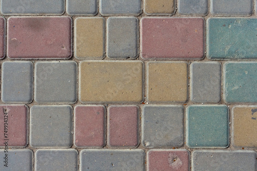 Close-up top view of multi colored tiled stine sidewalk on pedestrian city street. Copy space for your text or decoration. Abstract road background theme. photo