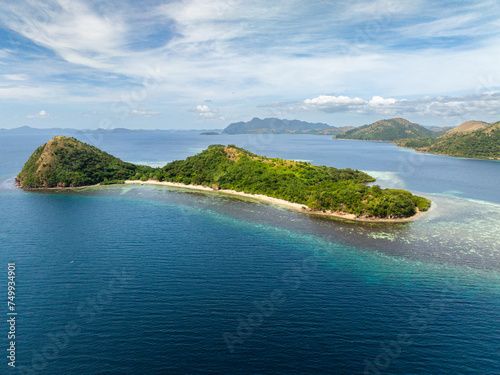 White sandy beach and turquoise sea water with corals in Dimanglet Island. Coron, Palawan. Philippines.