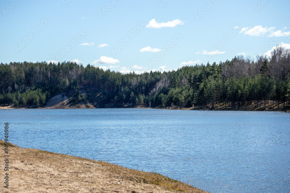 
Nature view with blue lake water sky and sandy beach