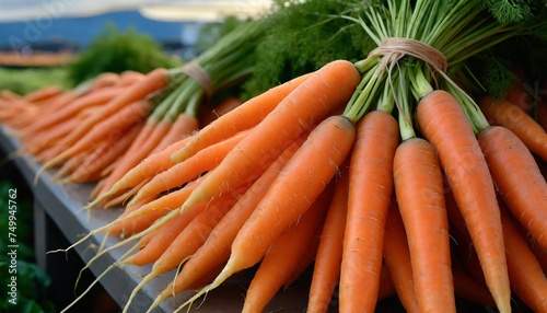 fresh orange carrots bunches for sale at a farmers market