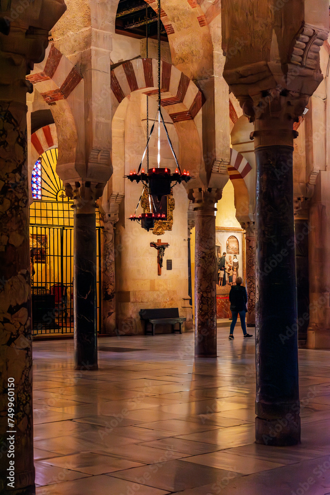 Interior of the cathedral mosque of Córdoba, a reflection of the two cultures and architectures, Christian figures and Muslim arches.