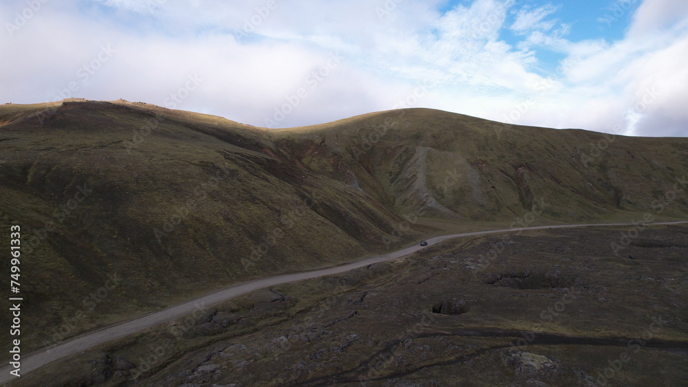 Car driving off-road terrain exploring the Fjallabak Natural Reserve. A 4x4 car driving dirt road traveling in Iceland sightseeing wilderness.