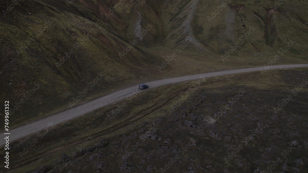 Car driving off-road terrain exploring the Fjallabak Natural Reserve. A 4x4 car driving dirt road traveling in Iceland sightseeing wilderness.