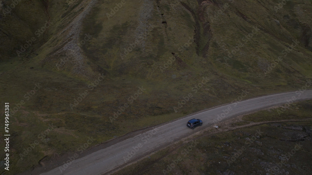 Car driving off-road terrain exploring the Fjallabak Natural Reserve. A 4x4 car driving dirt road traveling in Iceland sightseeing wilderness.