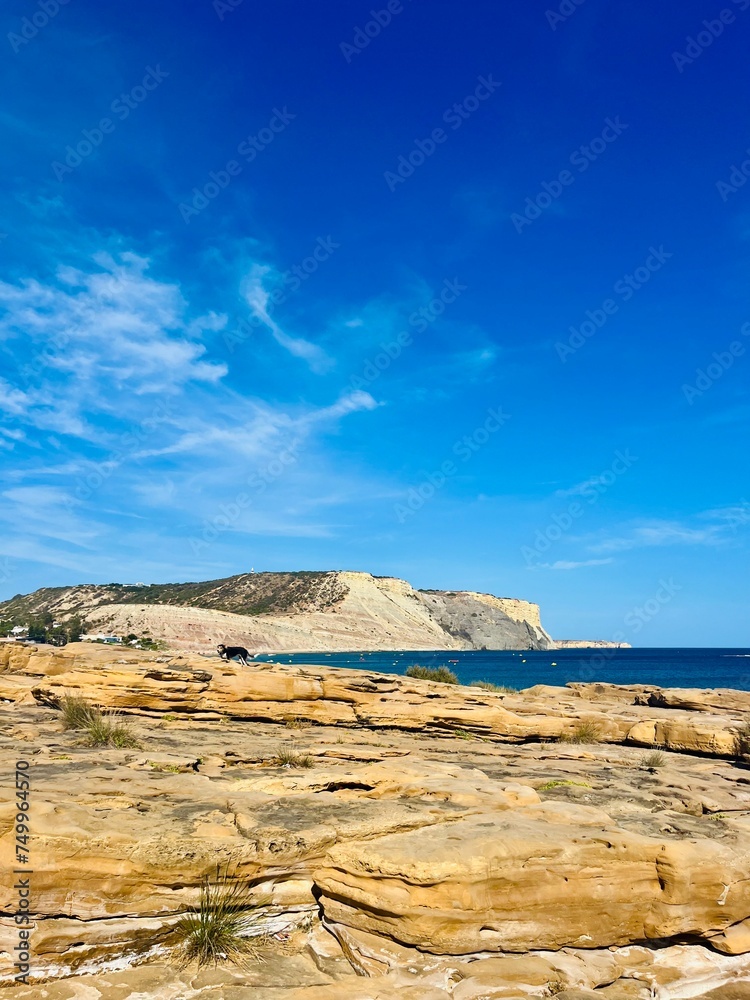 Beautiful azure ocean horizon, rocky coast, clear blue sky Beautiful azure ocean horizon, rocky coast, clear blue sky