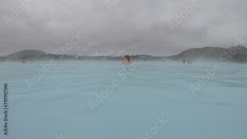 Obraz na płótnie The Blue Lagoon geothermal spa Iceland, in a lava field near Grindavík on Reykjanes Peninsula. Water's milky blue shade is due to its high silica content. Woman relaxes and enjoy of spa in hot spring. w salonie