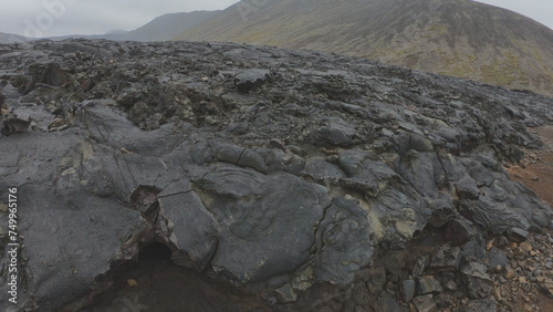Obraz na płótnie View of cracked lava crust or ingenious rock and steam cooled down from the 2021 eruption of Fagradalsfjall volcano in Geldingadalir Valley on Reykjanes Peninsula in Iceland. w salonie