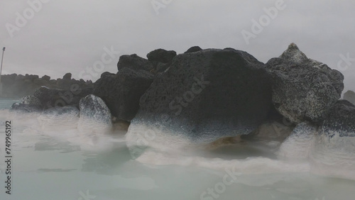 Obraz na płótnie The Blue Lagoon geothermal spa Iceland, in a lava field near Grindavík on Reykjanes Peninsula. Water's milky blue shade is due to its high silica content. Woman relaxes and enjoy of spa in hot spring. w salonie