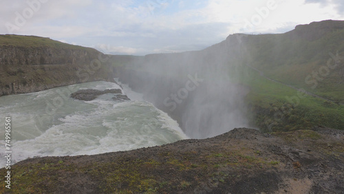 Gullfoss   Golden Falls   is a waterfall located in the canyon of the Hv  t   River in southwest Iceland. The rock of the river bed was formed during an interglacial period.