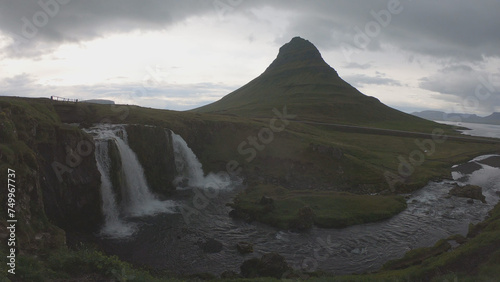 Waterfall Kirkjufellsfoss and Mount Kirkjufell. Kirkjufell is a picturesque mountain that rises above Grundarfjordur Town in the Snaefellsness Peninsula, Iceland. © An Instant of Time